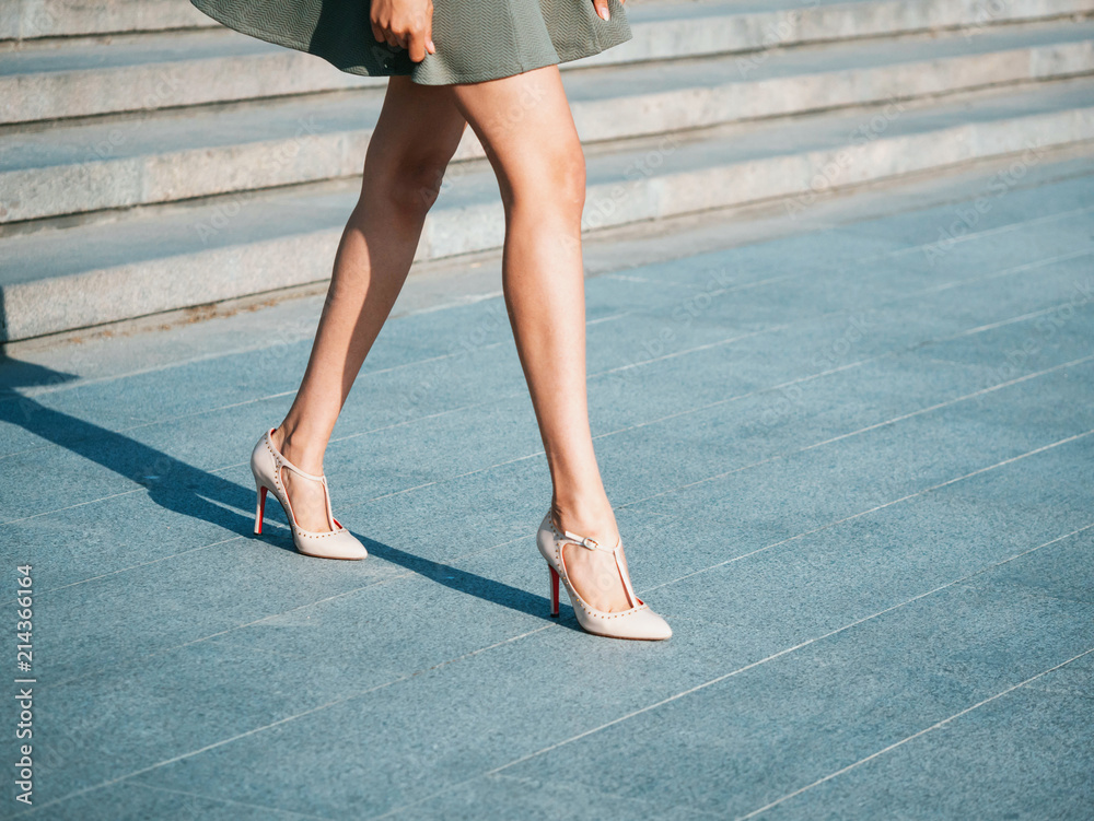 Sexy legs with high beige heels shoes on stone stairs of city. Business ...