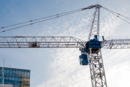 Photography Tall Crane in a Construction Site against Blue Sky.