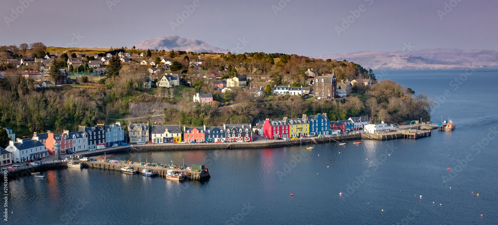 Aeial view in morning light of Tobermory Bay on the Isle of Mull. Scotland mainland highland peaks in the background