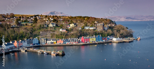 Aeial view in morning light of Tobermory Bay on the Isle of Mull. Scotland mainland highland peaks in the background photo