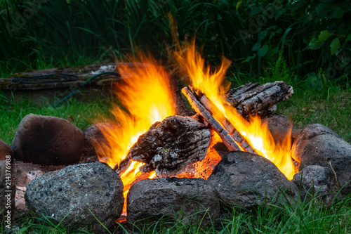 woods are burning in fireplace  warm  heat  fire. camping in nature in summer