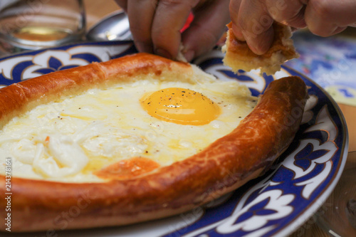 Adjarian khachapuri. Open the bread pie with cheese and egg. Traditional Georgian cuisine. photo