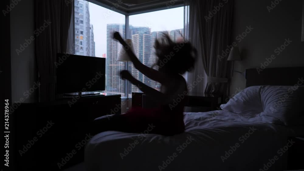 Happy woman jump on bed and relax Happy woman jump on bed and relax