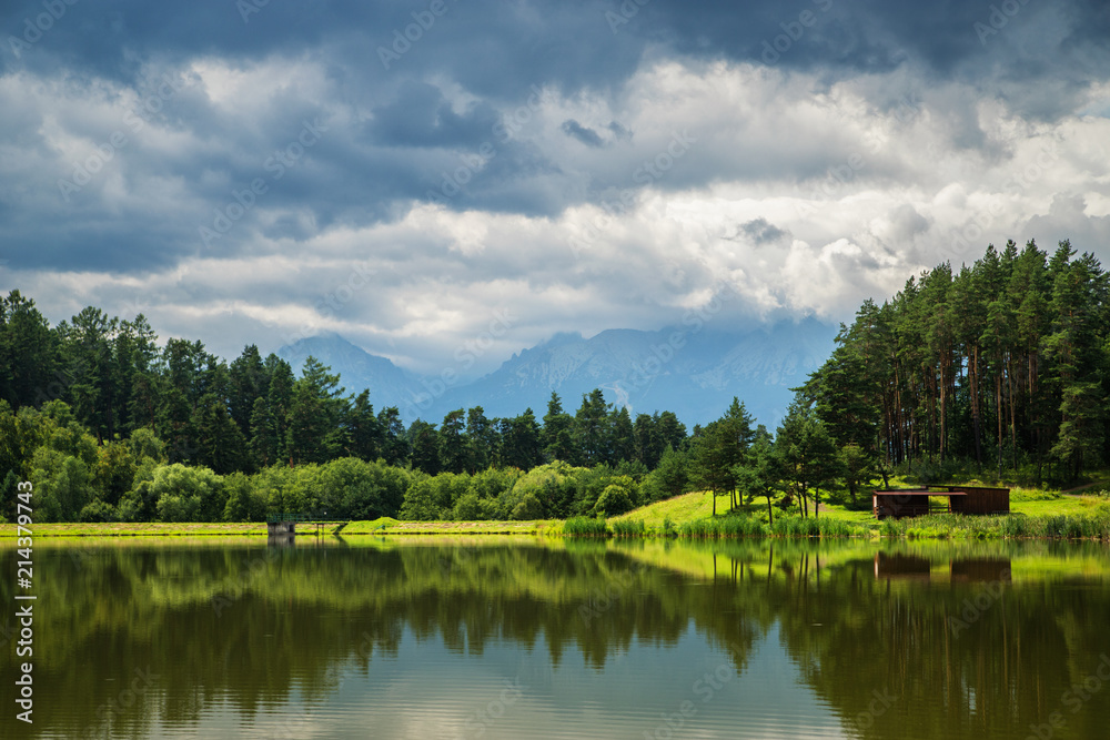 Lake and forest with mountains and clouds in background, Slovakia