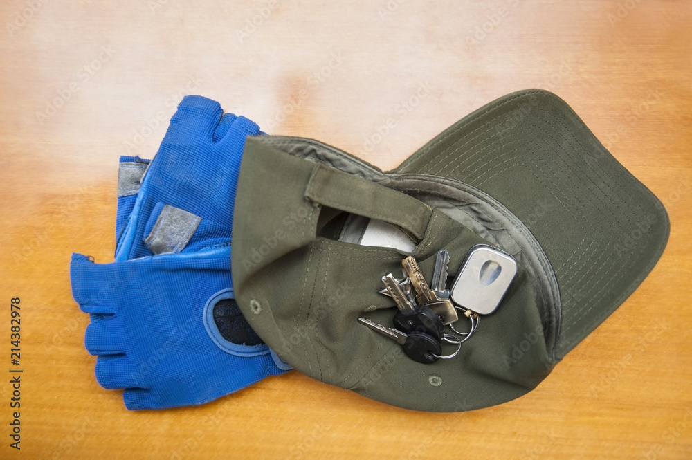 Necessary accessories for safe riding a bike - cap, сycling gloves and keys for locks
