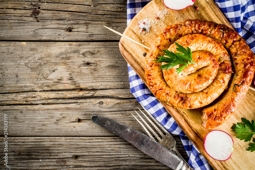 Oktoberfest food menu, bavarian sausages on wooden background, copy space above