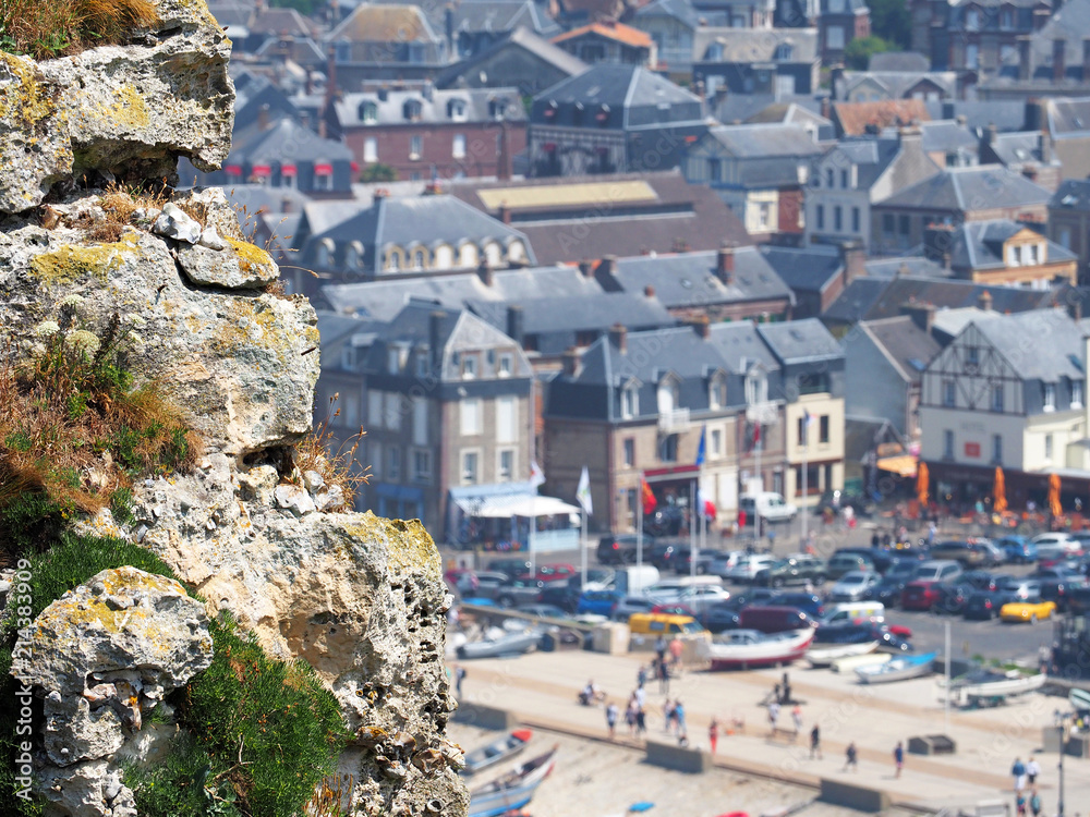 Picturesque landscape of Etretat commune, view of the ancient city from the cliffs. Etretat, Normandy, France. Coast of the Pays de Caux area in sunny summer day, tourists and holidaymakers