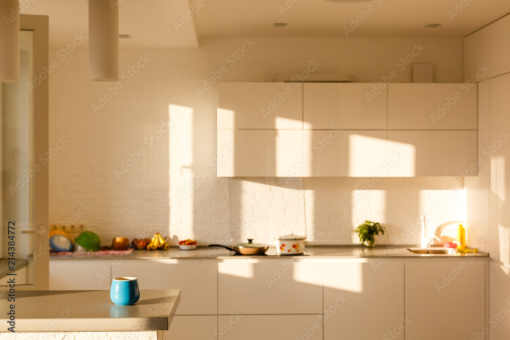 Beautiful Kitchen Interior Detail in New Luxury Home at Sunrise. Features Farmhouse Sink, Elegant Pendant Light Fixtures Beautiful Kitchen Interior Detail in New Luxury Home at Sunrise. Features Farmhouse Sink, Elegant Pendant Light Fixtures
