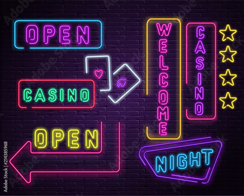 Neon luminous welcome casino signs on purple bricklaying wall.