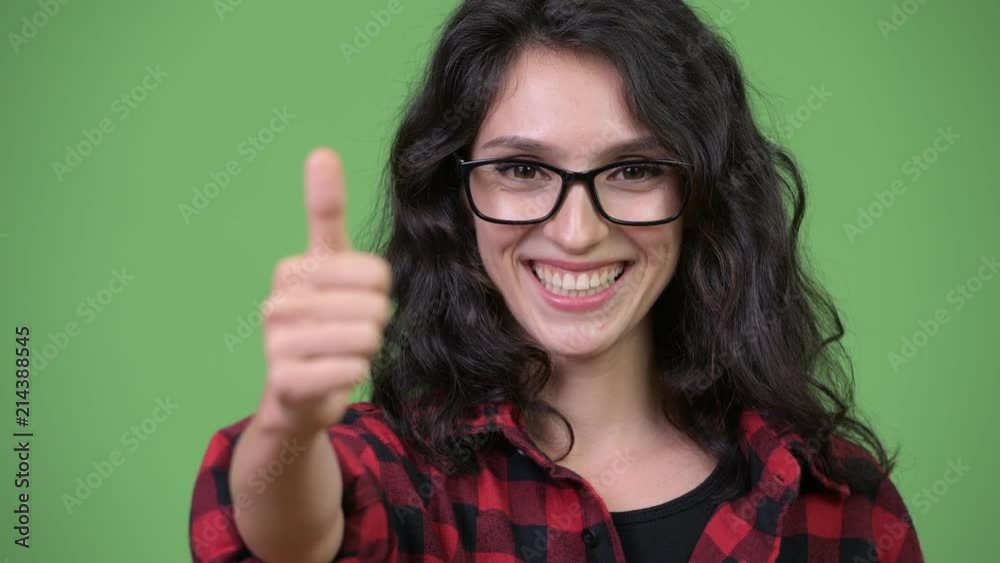 Young beautiful businesswoman giving thumbs up