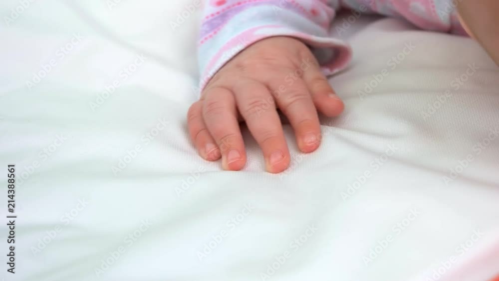 Small delicate hand of newborn. Infant baby hand on white blanket. Small delicate hand of newborn. Infant baby hand on white blanket.