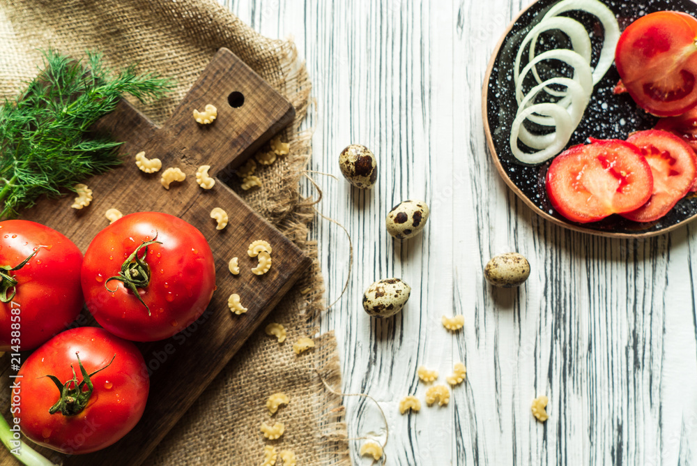 tomatoes, green onions, dill, quail eggs on a white board 4 tomatoes, green onions, dill, quail eggs on a white board 4