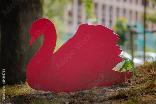 Wooden bird on thegrass and shadows in the sun set photo