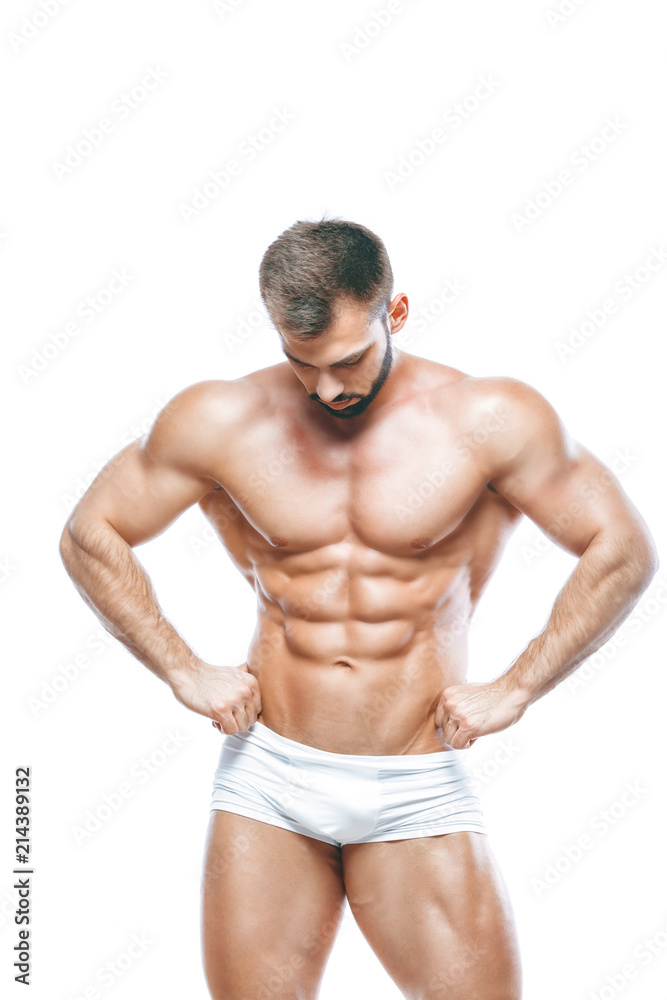 bodybuilder posing. Beautiful sporty guy male power. Fitness muscled manin white lingerie. on isolated white background. bodybuilder posing. Beautiful sporty guy male power. Fitness muscled manin white lingerie. on isolated white background.