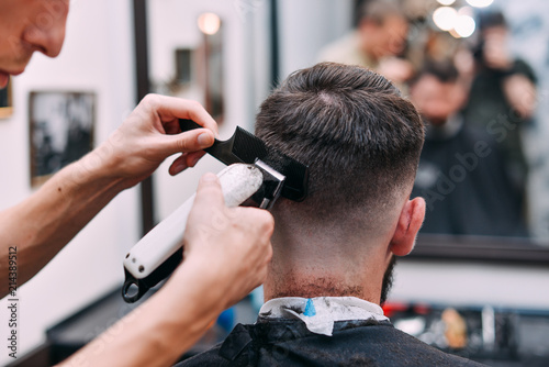 A man is hanging around in a beauty salon. Haircut and styling in barbershop. Men's care for beard and hair.
