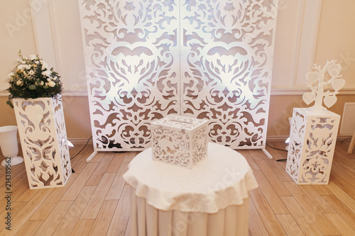 wedding photo zone. stylish white photo booth with flowers at wedding reception in restaurant