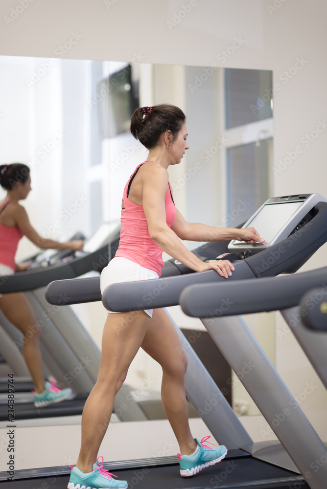 middle age woman running in sports club middle age woman running in sports club