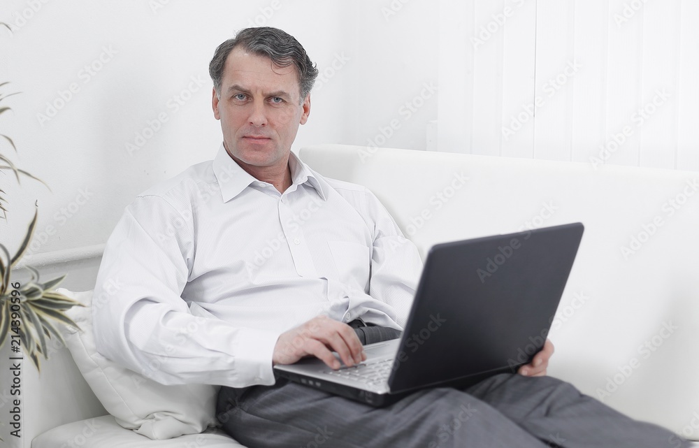 businessman with laptop works in the room