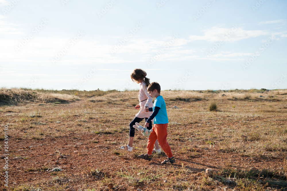 poor refugees children walking across desert escaping war conflict and violence