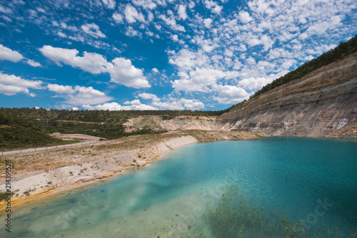 Turqoise lake in an open pit mine