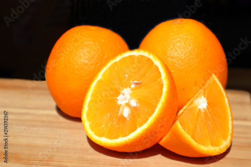 oranges whole and cut on the table