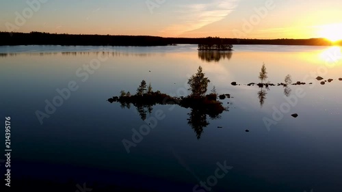 Wallpaper Mural Drone shot of a bird flying back and forth over a lake in a forest in Sweden during sunset. Reflection in lake. Torontodigital.ca