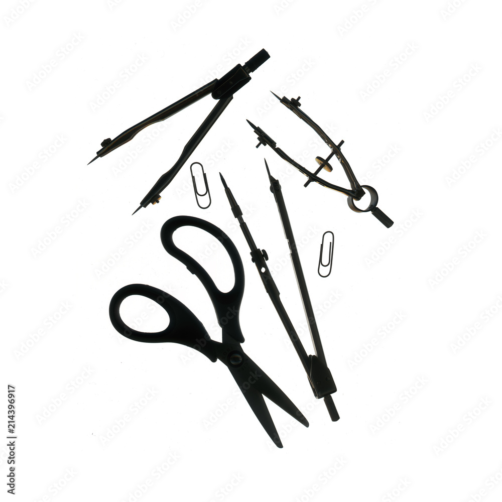 Retro compasses, clip and scissors on gray background. Retro compasses, clip and scissors on gray background.
