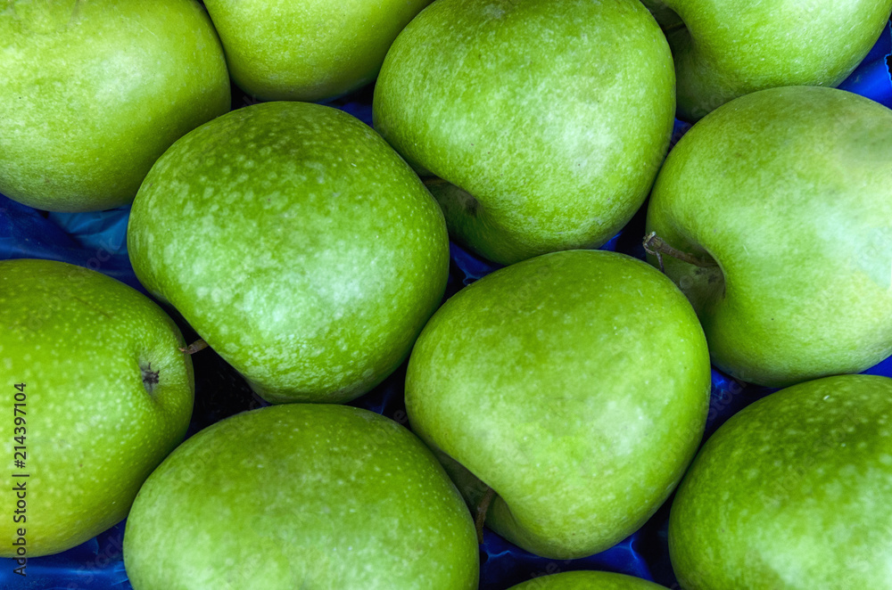 Pile of fresh ripe green apples at a local market Pile of fresh ripe green apples at a local market