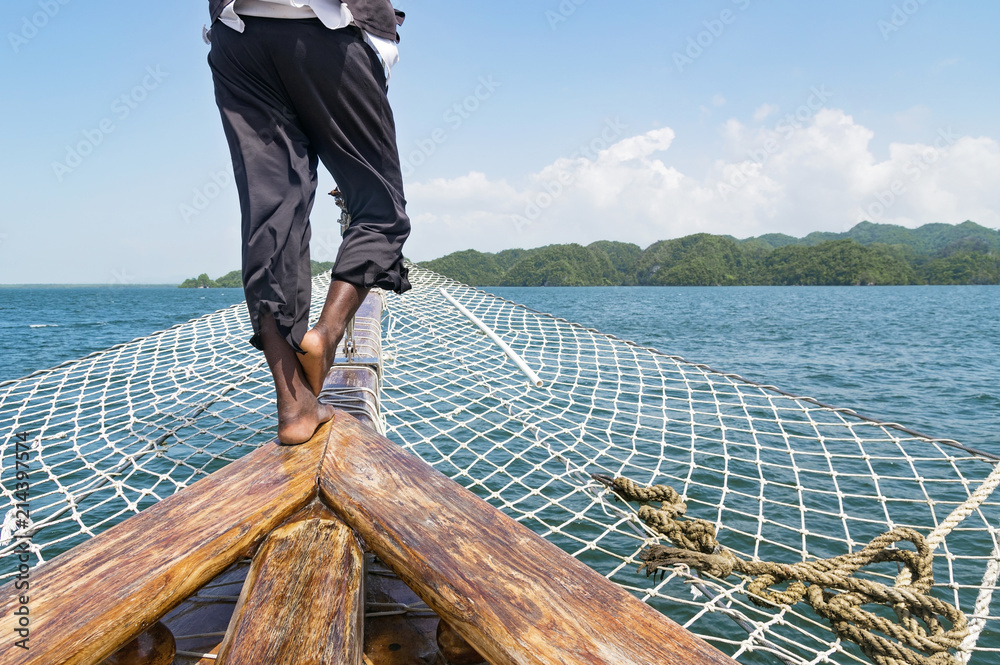 Naklejka premium Cropped image of the man in a pirate costume on the old sailing ship. Concept of freedom and adventures. Place for text or design