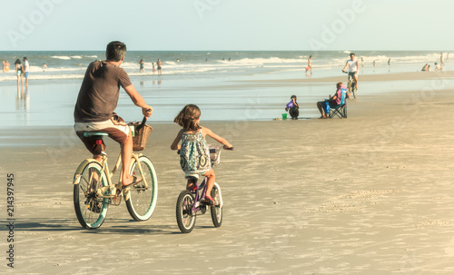 Father and Daughter Biking on Beach, Retro Look