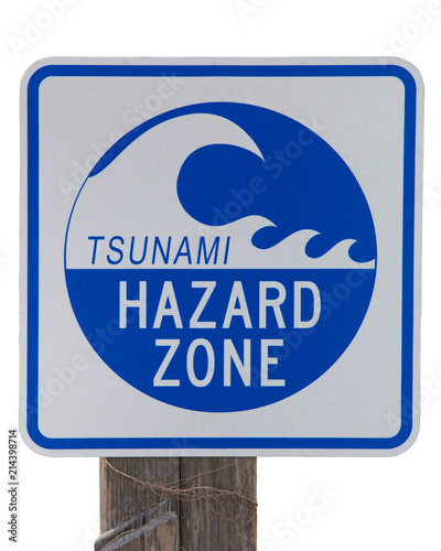 Tsunami Hazard Zone warning sign on an old wood post isolated on white background. photo