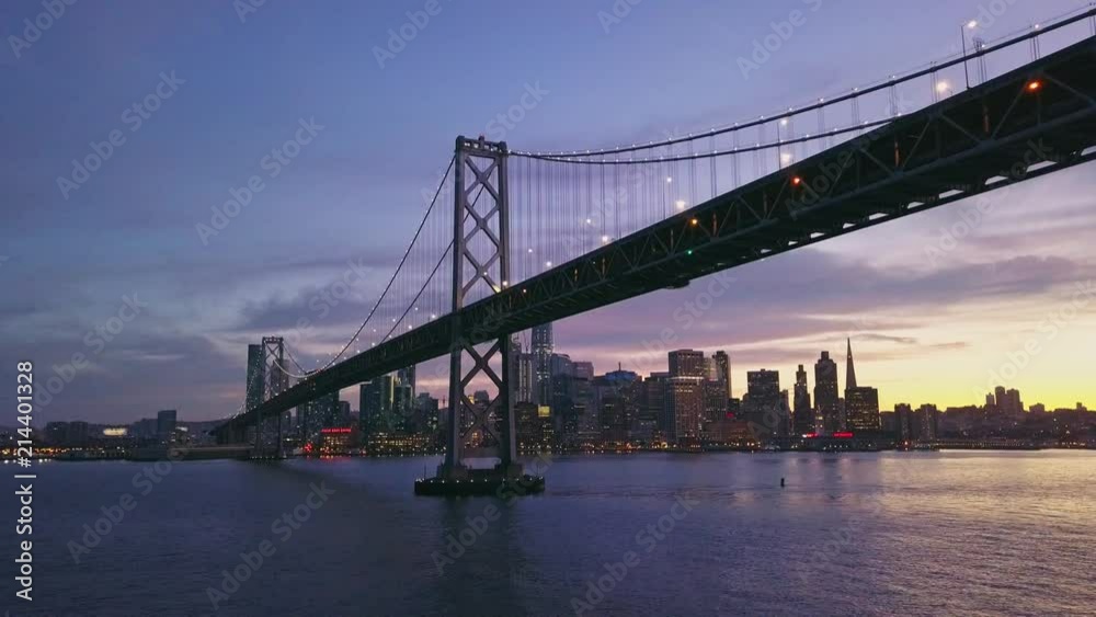Aerial cityscape flythrough video of the Bay Bridge and San Francisco skyline with colorful sunset Aerial cityscape flythrough video of the Bay Bridge and San Francisco skyline with colorful sunset
