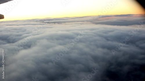 Flight over white clouds in the evening