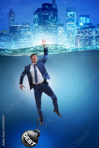 Businessman drowning in concept of high debt © Elnur