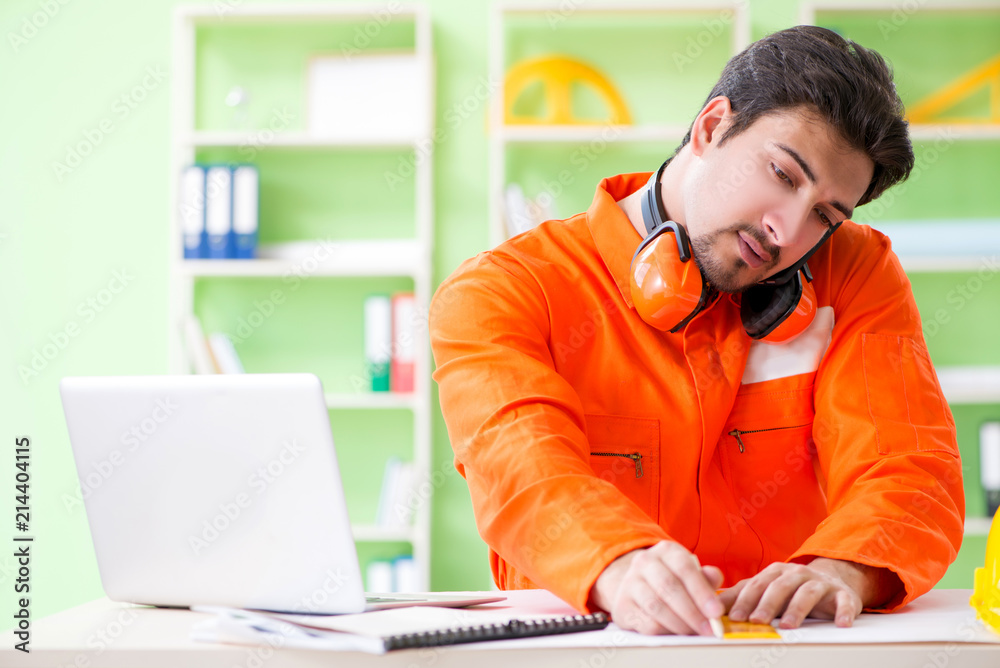 Construction supervisor planning new project in office Construction supervisor planning new project in office