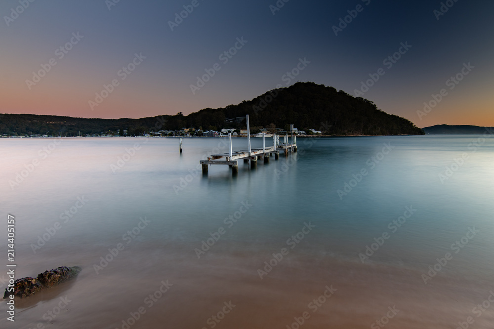 Fototapeta premium Sunset waterscape and old wharf