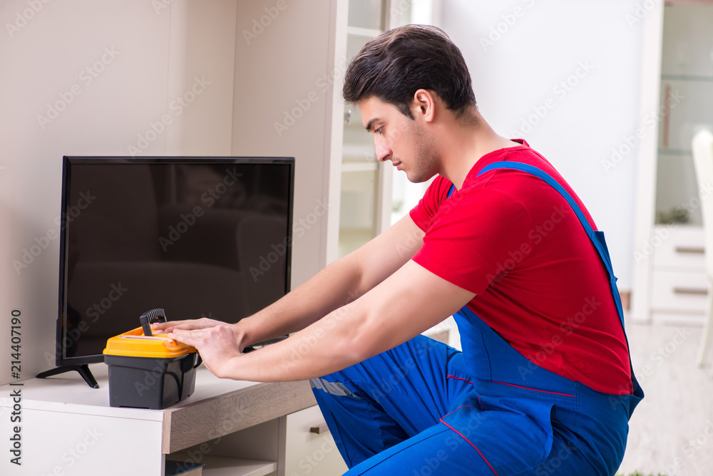 Professional repair engineer repairing broken tv Professional repair engineer repairing broken tv