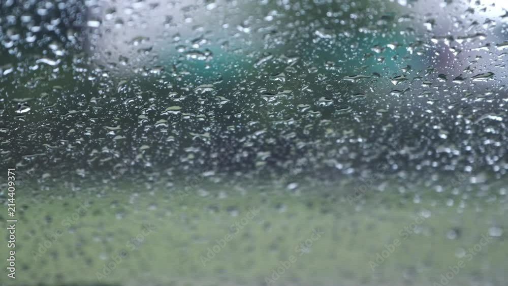 Raindrops outside the window with green nature background Raindrops outside the window with green nature background