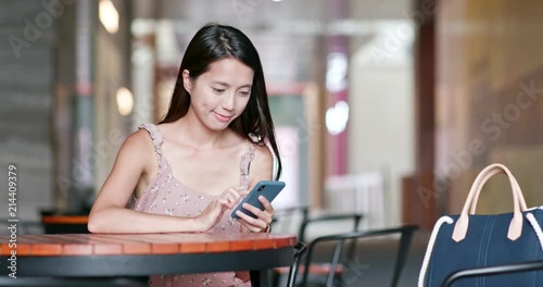 Woman use of smart phone in outdoor cafe photo