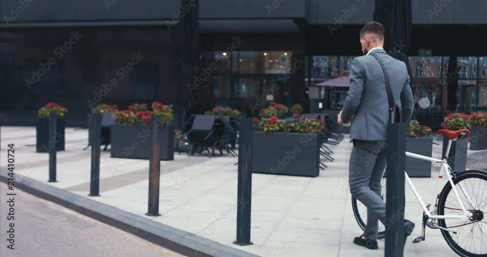custom made wallpaper toronto digitalTRACKING Handsome young adult man wearing suit having a coffee before riding his classic bicycle to work in the morning. 4K UHD 60 FPS SLOW MOTION