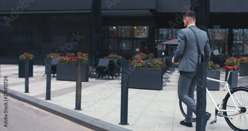 Wallpaper Mural TRACKING Handsome young adult man wearing suit having a coffee before riding his classic bicycle to work in the morning. 4K UHD 60 FPS SLOW MOTION Torontodigital.ca