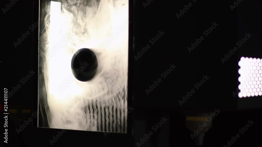 SMOKE being released into a wind tunnel allowing AIR MOVEMENTS to be OBSERVED by means of SMOKE FILAMENTS released at suitable points creating the SMOKE TUNNEL