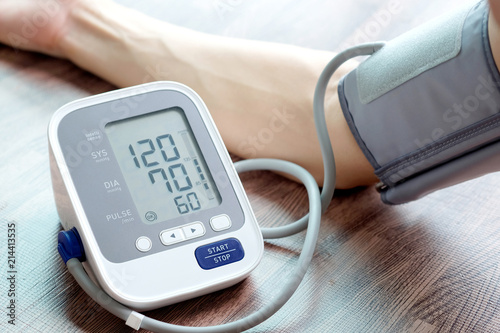 Man check blood pressure monitor and heart rate monitor with digital pressure gauge. Health care and  Medical concept photo