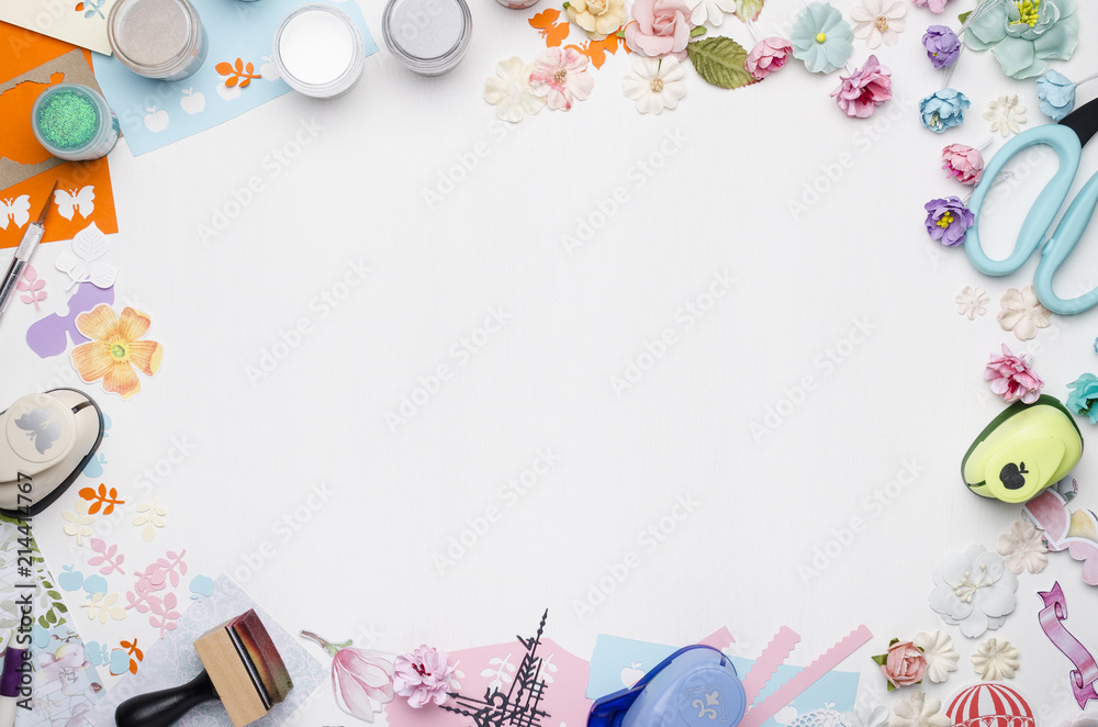 Empty white space in the center surrounded by paper flowers, multi-colored paper and scrapbooking materials. Top view Empty white space in the center surrounded by paper flowers, multi-colored paper and scrapbooking materials. Top view