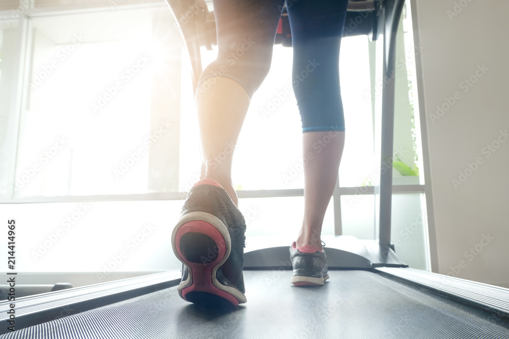 leg of woman running exercise on treadmill in the gym which runner athletic by running shoes. Health and sport concept background, leg of woman running exercise on treadmill in the gym which runner athletic by running shoes. Health and sport concept background,