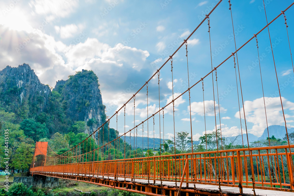 Fototapeta premium Orange bridge over song river Landmark in Vang Vieng,Laos