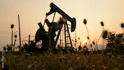 pumpjack at an oil drilling site photo