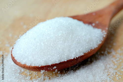 White sugar in spoon wooden on the table  Healthy Diet Concepts