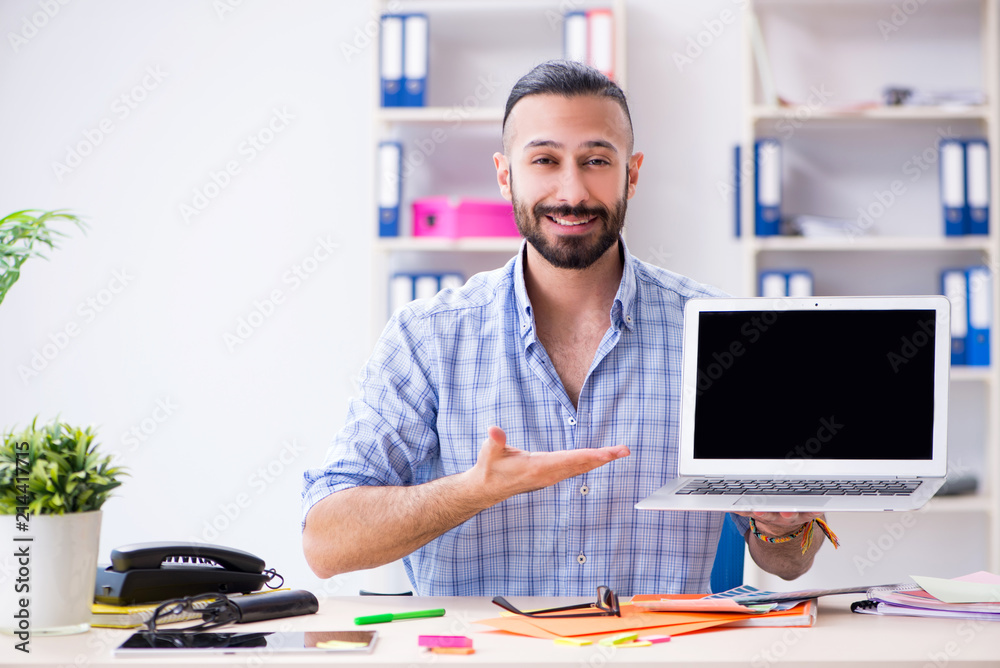 Young designer working in his studio on new project Young designer working in his studio on new project