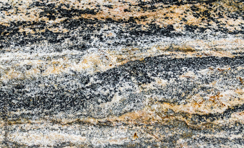 background texture-close up of black, gray, white and orange patterns in volcanic rock from Montana